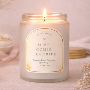 Candle with 'Here Comes the Bride' label on a soft background