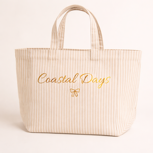 Beige striped tote bag with 'Coastal Days' text on a light background