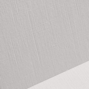 Close-up of gray textured fabric with a white surface underneath