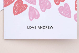 Card with pink hearts and 'LOVE ANDREW' text on a beige background