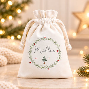 Personalised Millie hot chocolate gift bag with green wreath, red star and Christmas tree artwork