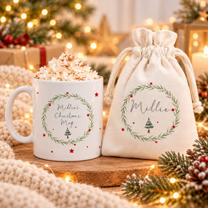 Christmas tree personalised mug and drawstring hot chocolate gift bag in a cosy festive setting