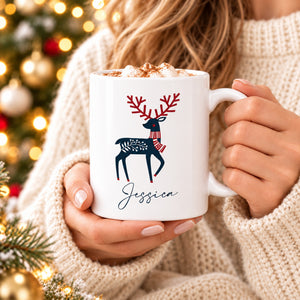 Woman in cream jumper holding personalised Scandinavian reindeer Christmas mug