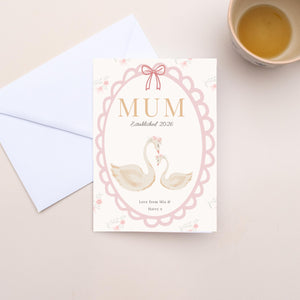 Greeting card for 'Mum' with swan design and envelope on a light surface.