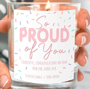 Close-up of a personalised So Proud of You congratulations candle