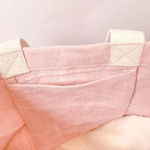 Inside detail of Amy Lucy Mama Essentials washed jute bag showing internal pocket, reinforced stitching and woven shoulder handles