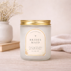 Candle with a 'Brides Maid' label on a light surface