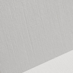 Close-up of gray textured fabric with a white surface underneath