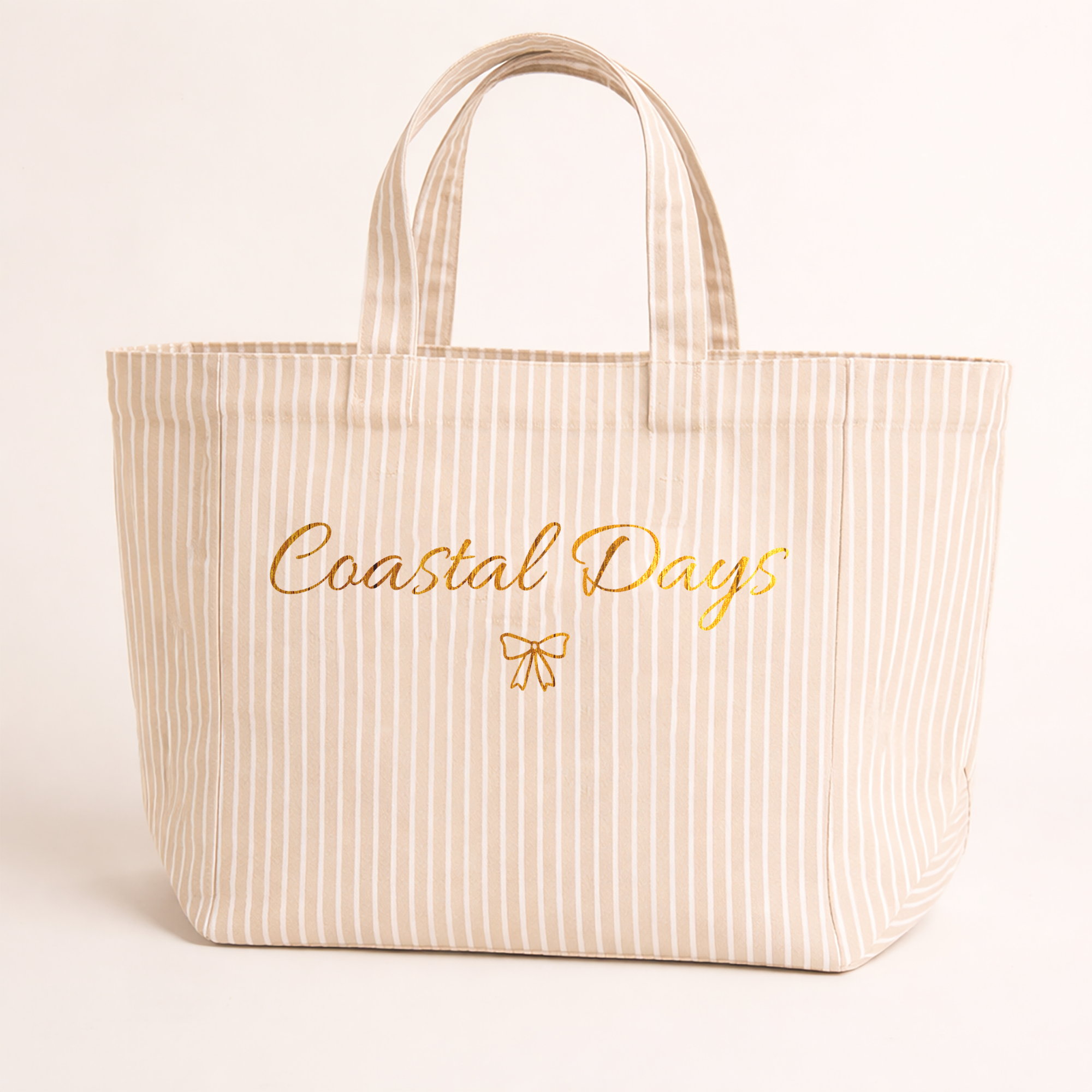 Beige striped tote bag with 'Coastal Days' text on a light background