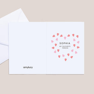 Greeting card with heart design and text on a beige background