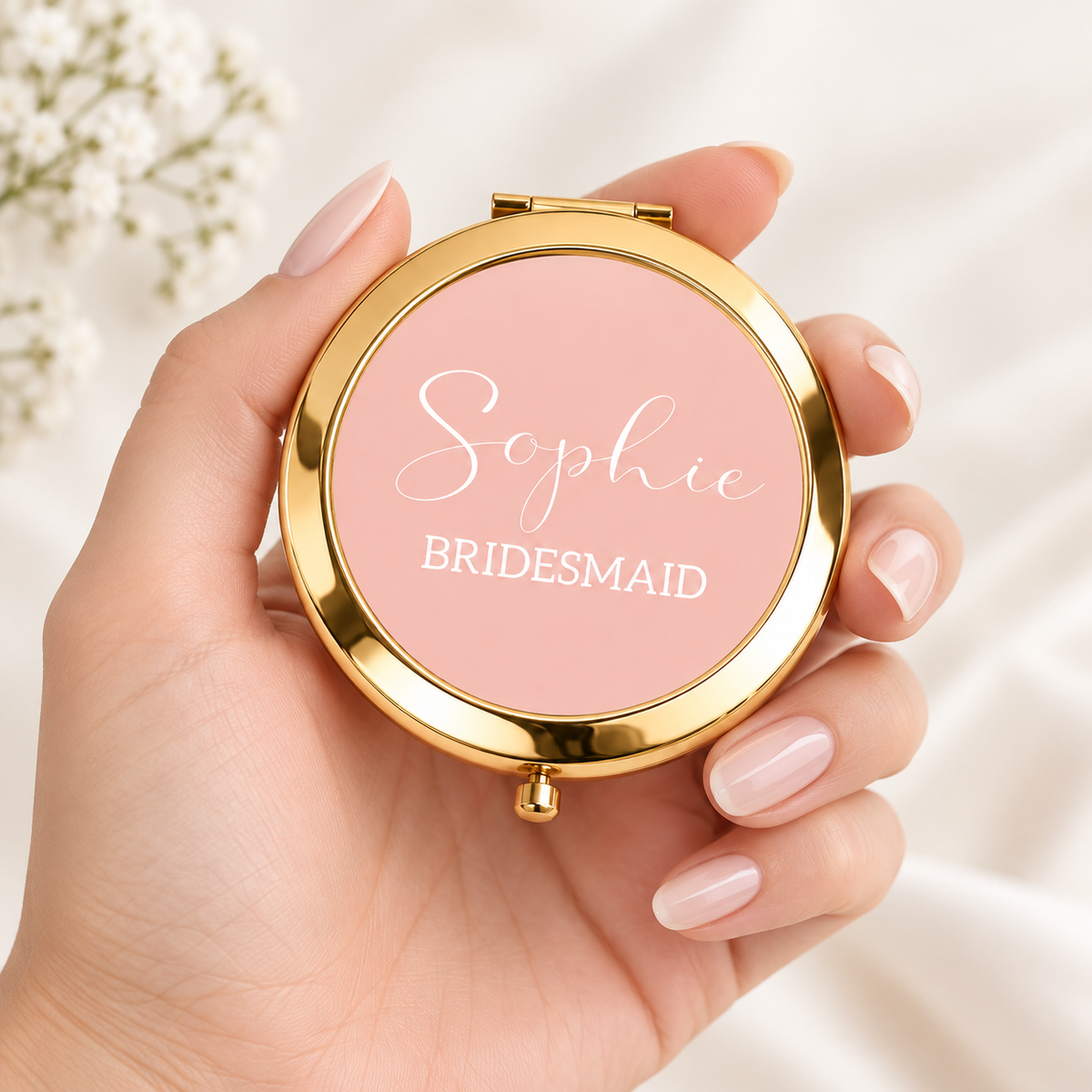 Gold bridesmaid compact mirror held in hand