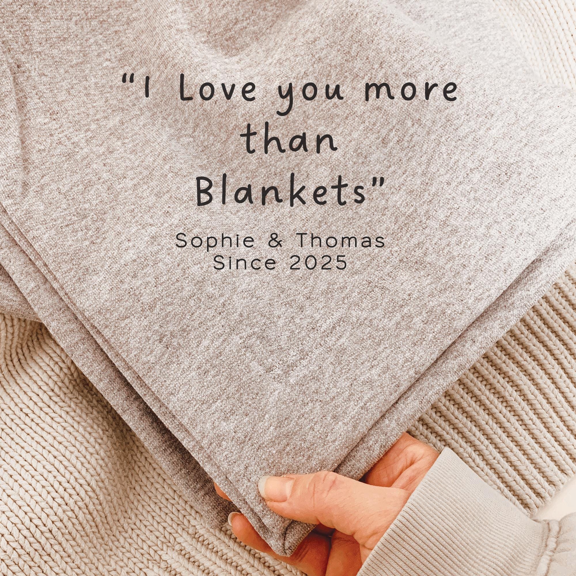 Folded blanket with text 'I Love you more than Blankets' and names 'Sophie & Thomas Since 2025'.