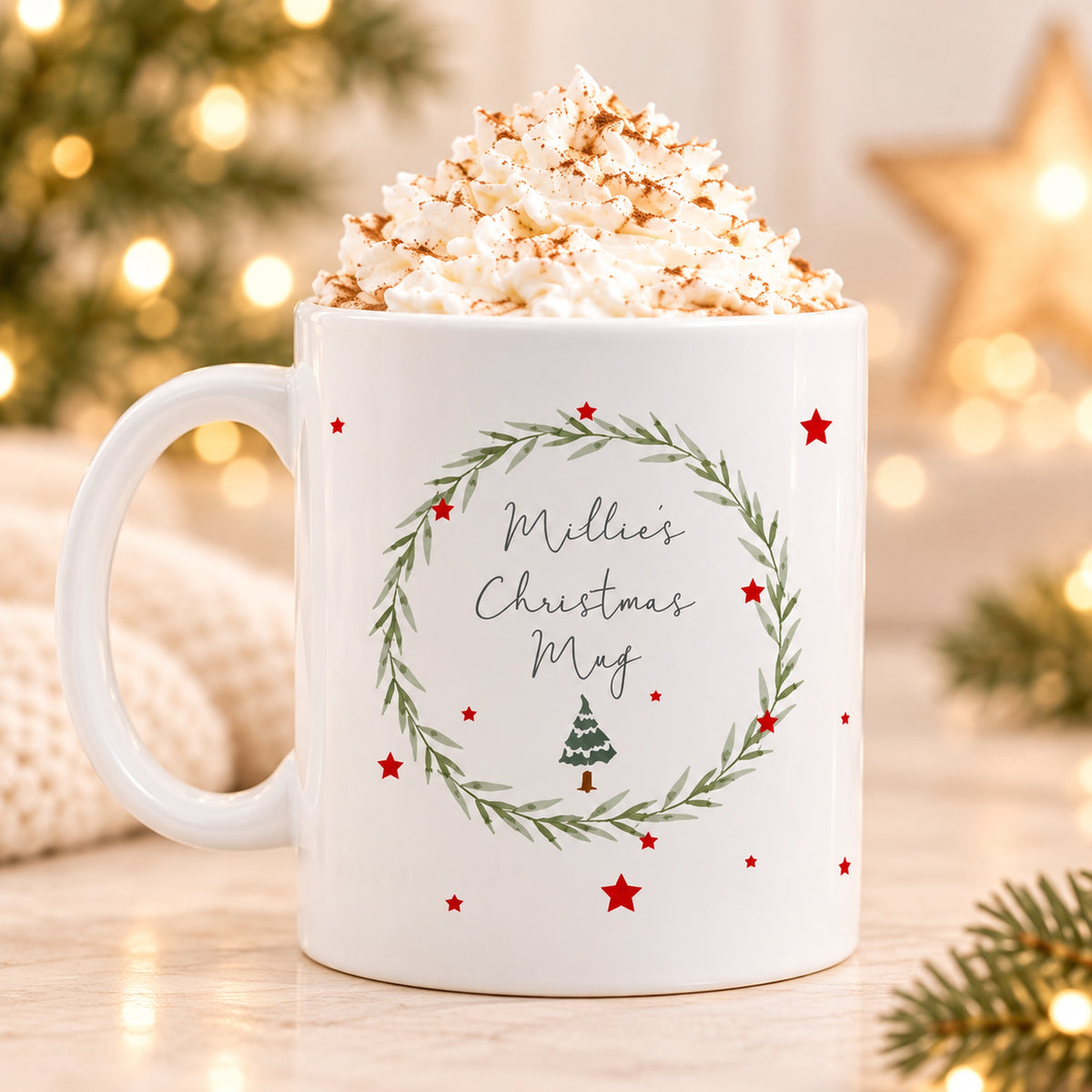 White personalised Millie's Christmas Mug with green wreath, red stars and Christmas tree design
