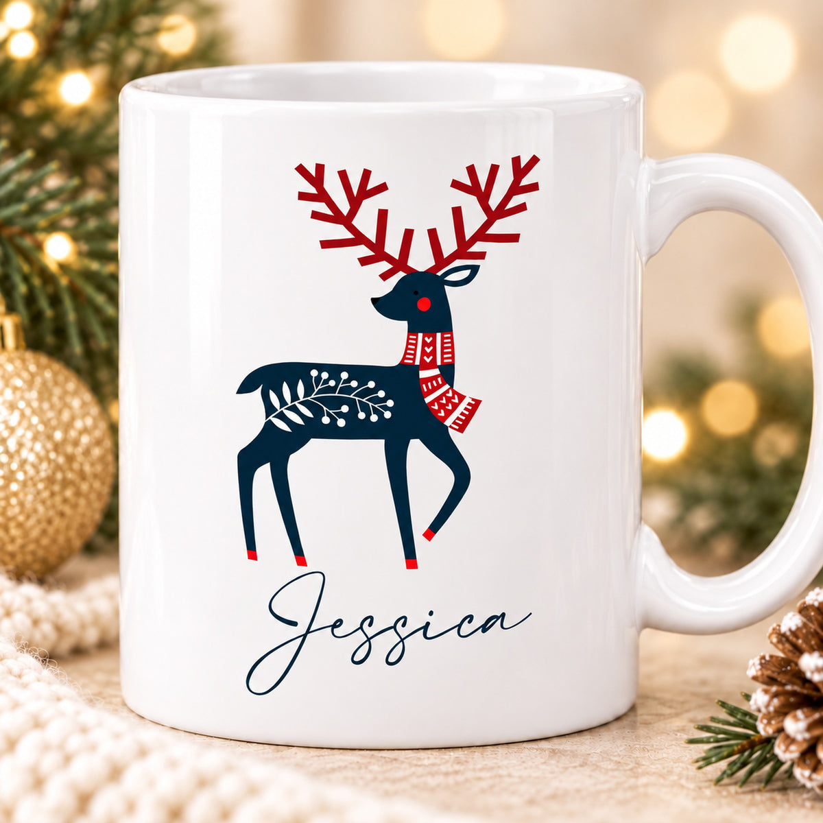 Close-up of navy and red Scandinavian reindeer artwork and Jessica personalisation on Christmas mug