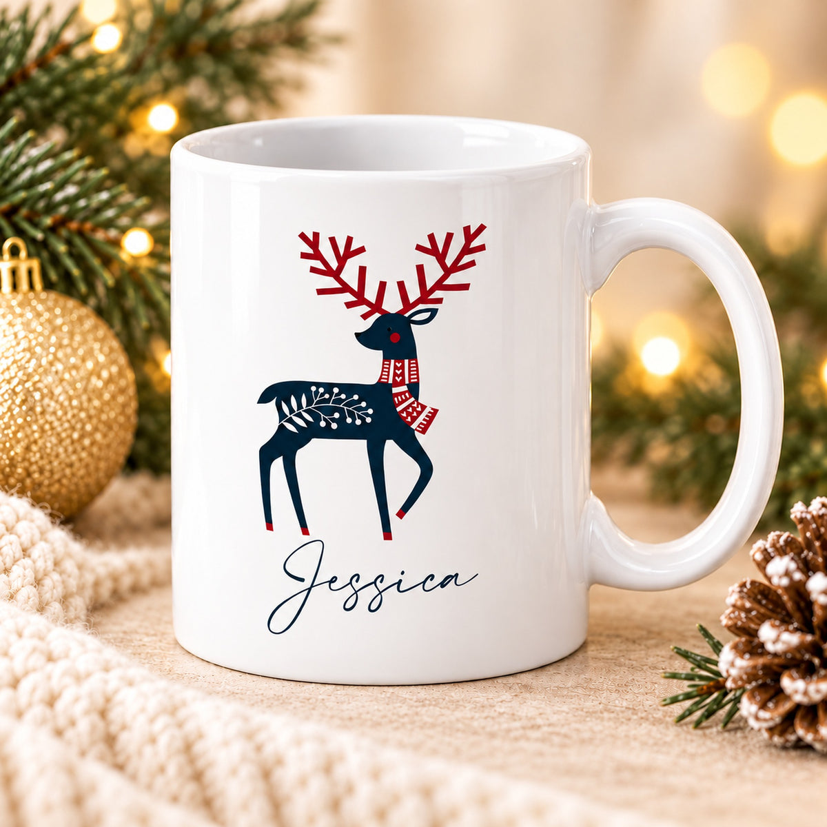 Angled white personalised reindeer Christmas mug with festive pine decorations