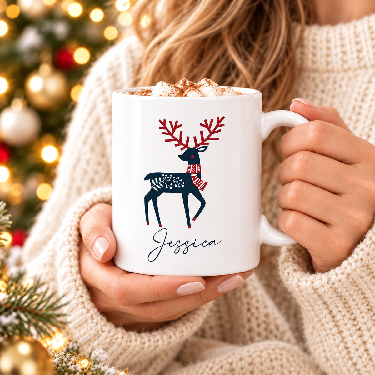 Woman in cream jumper holding personalised Scandinavian reindeer Christmas mug