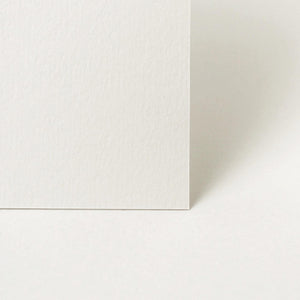Two sheets of white paper stacked on a light gray background