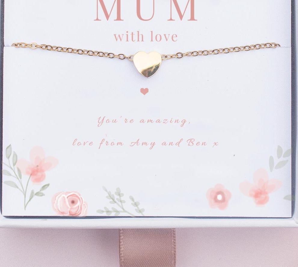 Gold heart bracelet on a card with 'Mum with love' text and floral design