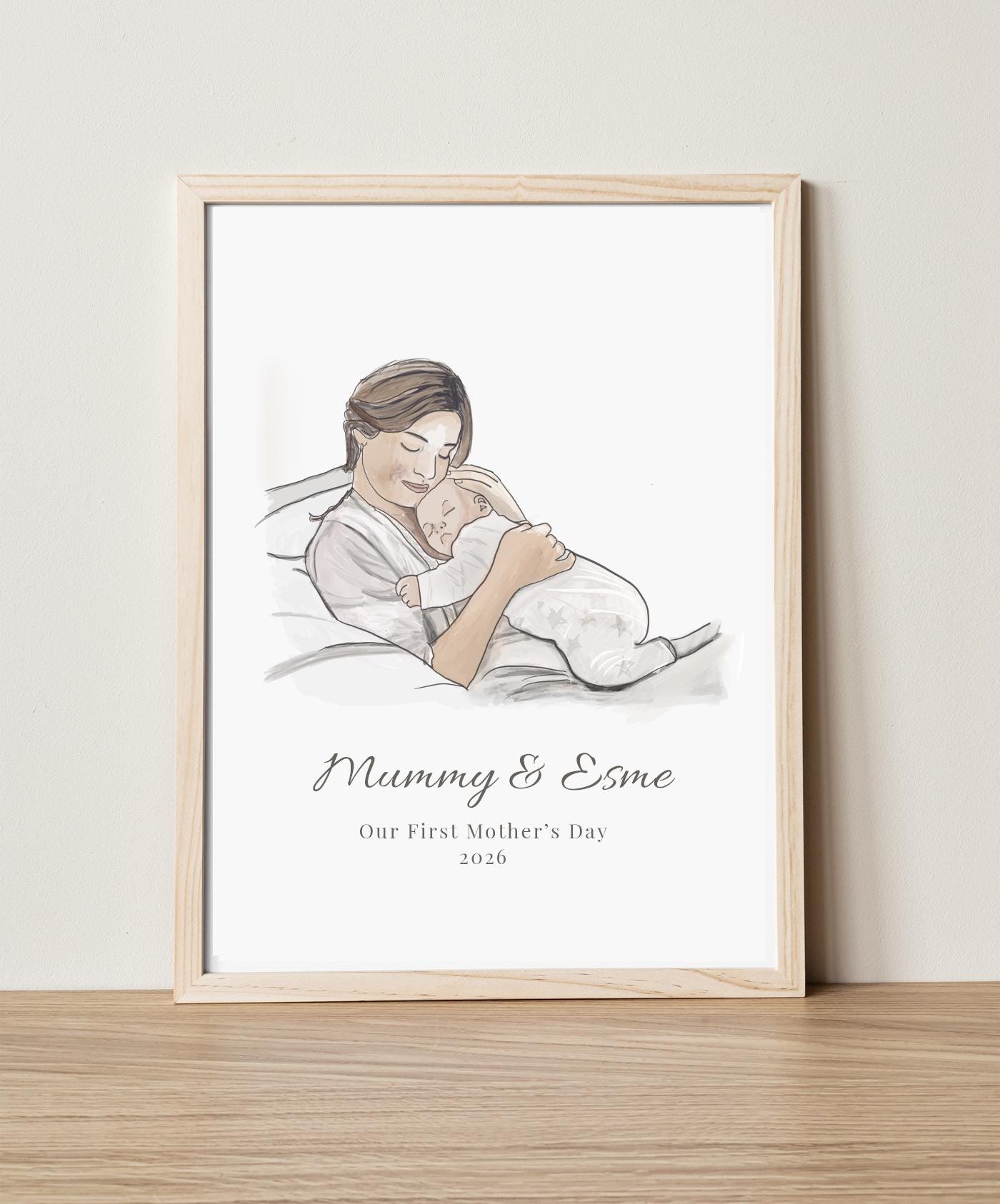 Framed artwork of a mother holding a baby with 'Mummy & Esme' text on a light background