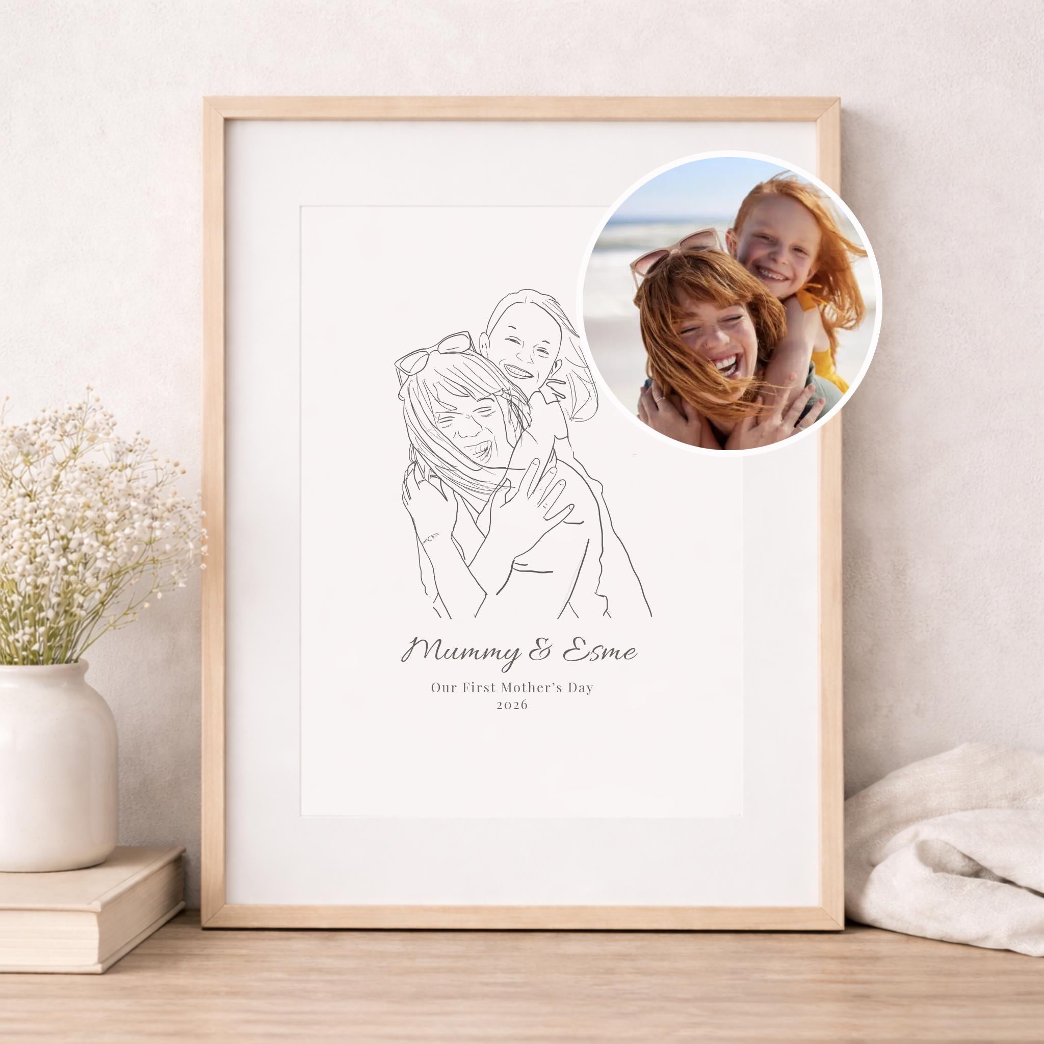 Framed line drawing of a mother and child with a photo inset on a wall.