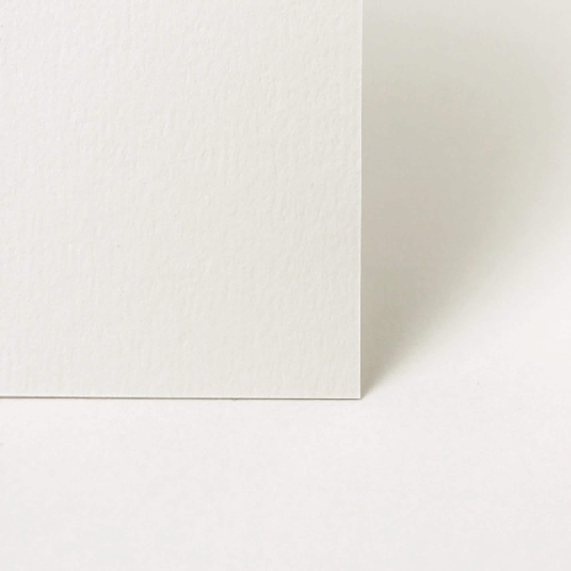 Two white square tiles with a corner overlap on a light gray background