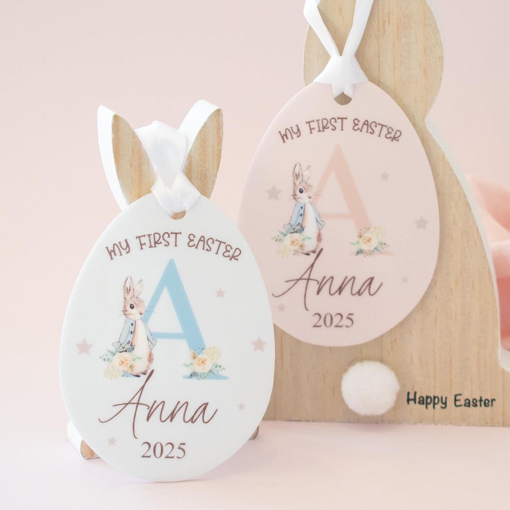 Personalized Easter egg ornaments with bunny design and text on a pink background