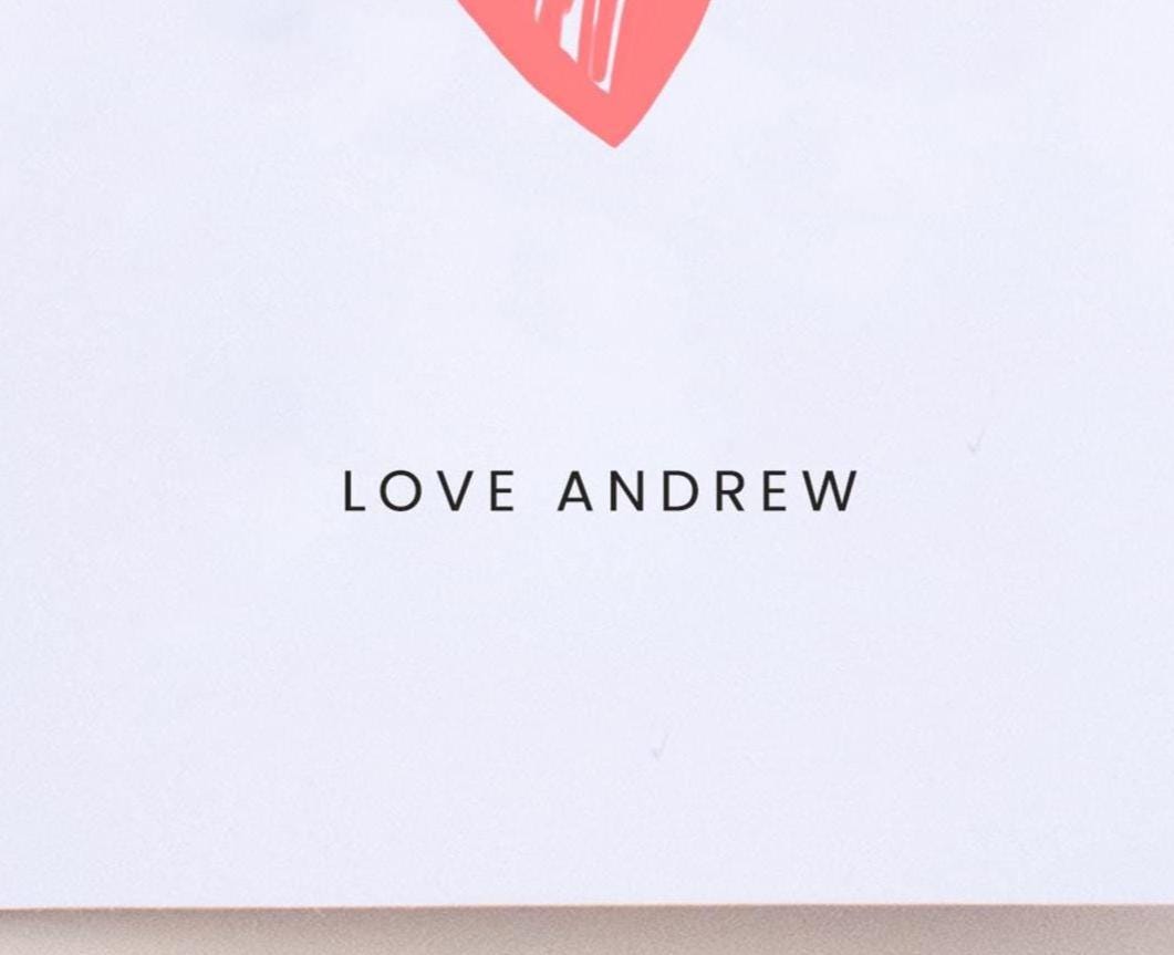 Card with 'LOVE ANDREW' text and a red heart on a white background
