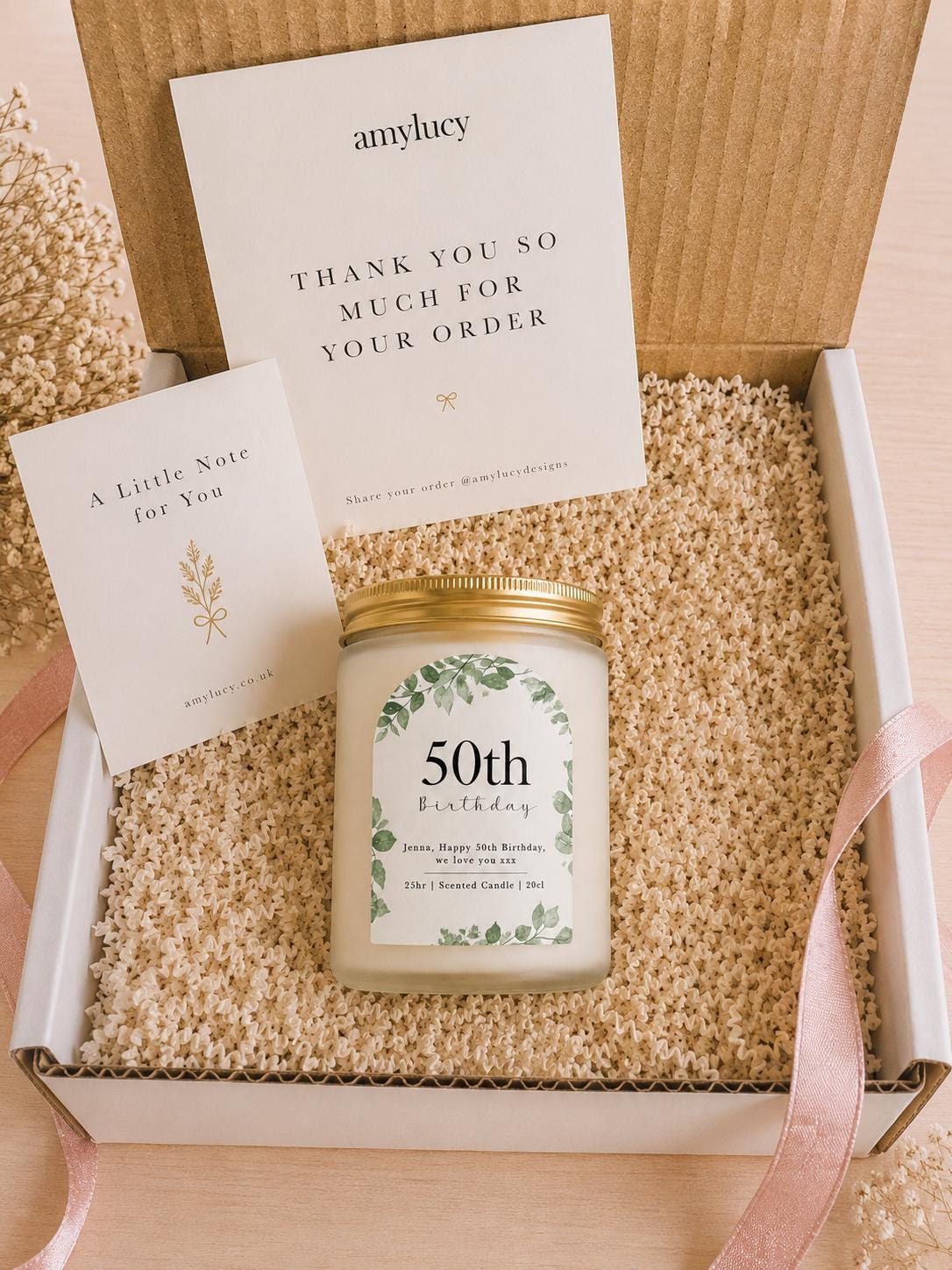 Lit personalised Botanical Birthday Candle Gift in a styled setting