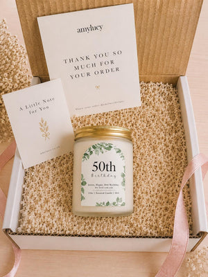 Lit personalised Botanical Birthday Candle Gift in a styled setting