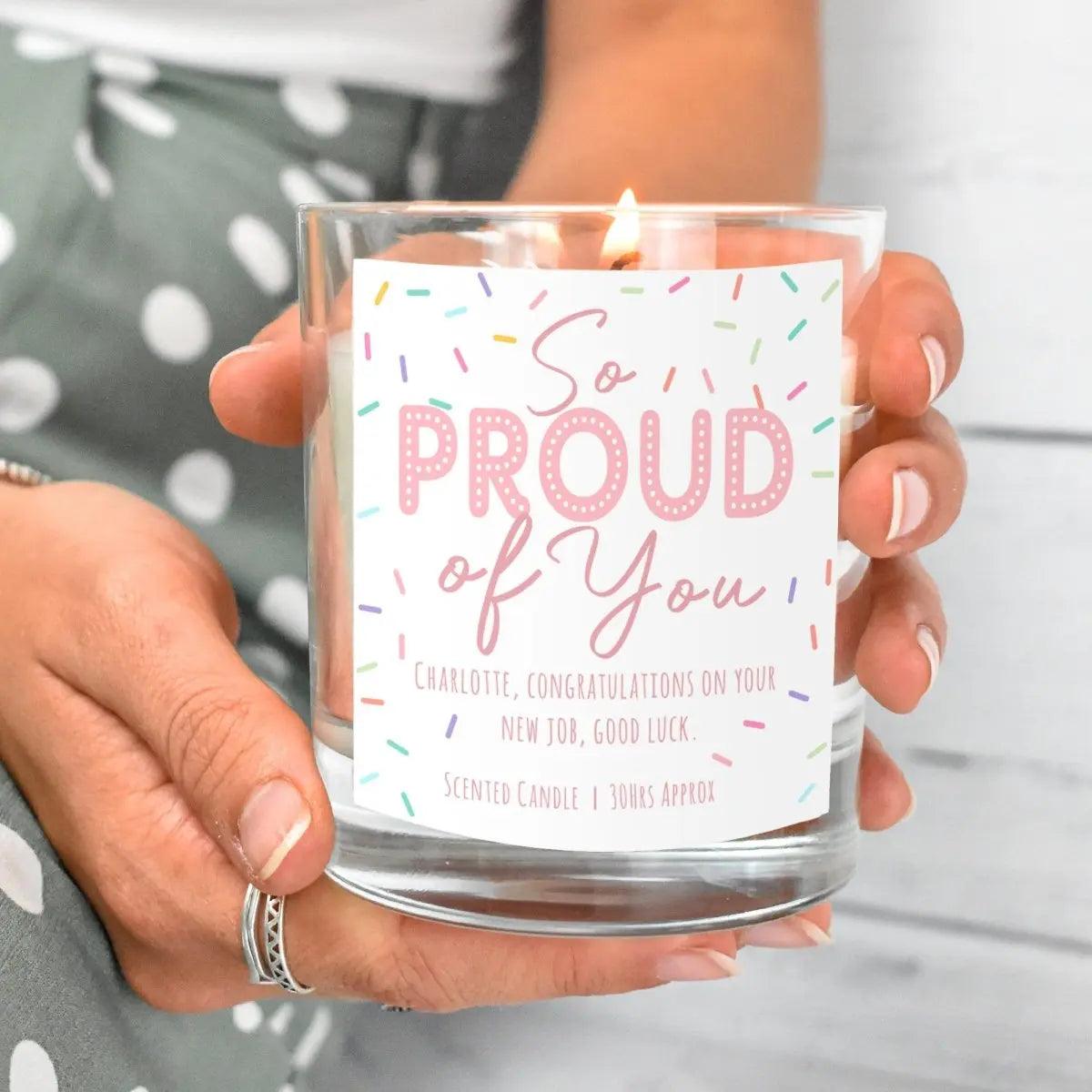 Personalised congratulations candle held with the label facing forward