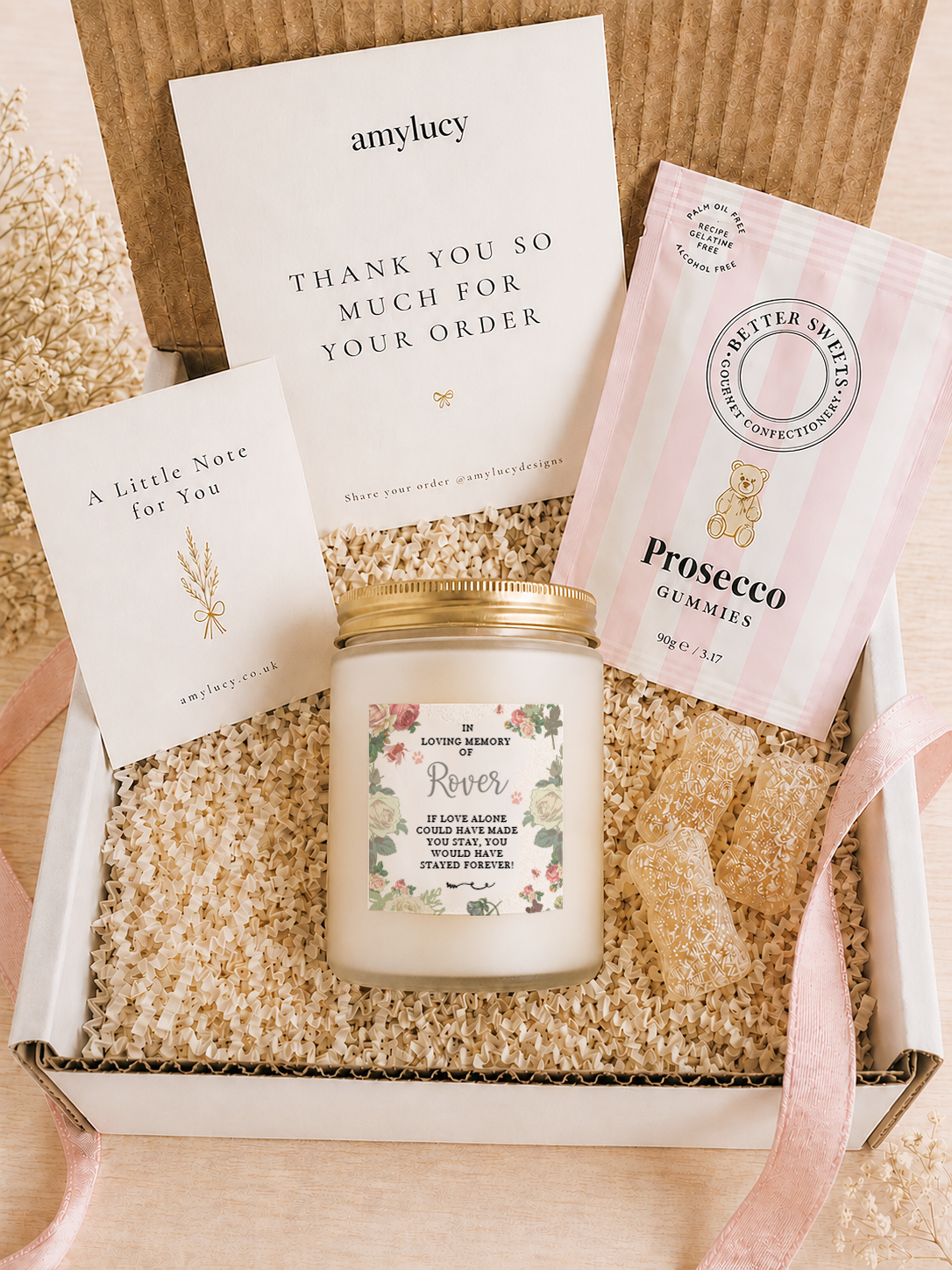 Lit personalised Floral Pet Memorial Candle in a styled setting