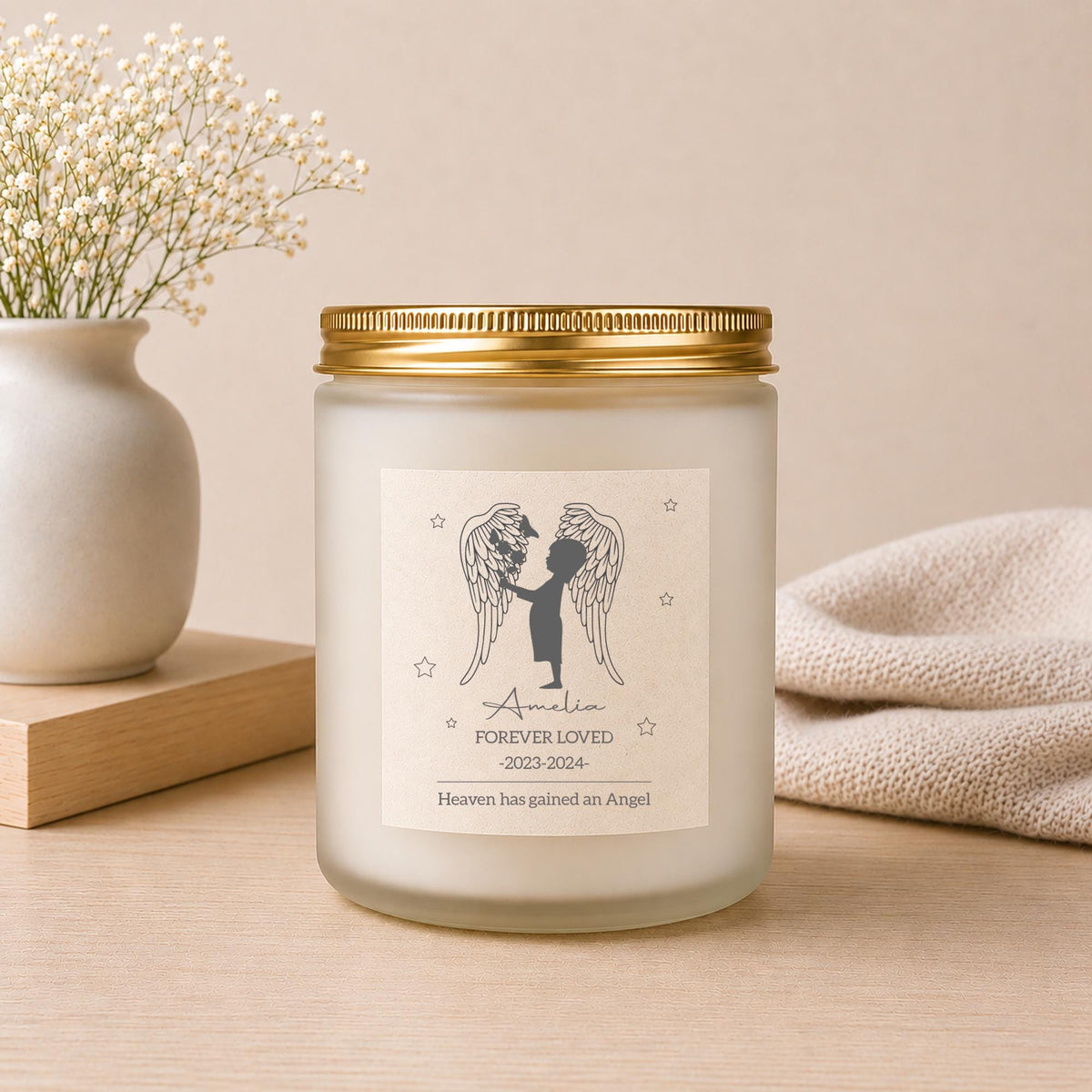 Lit personalised Miscarriage Memorial Candle in a styled setting