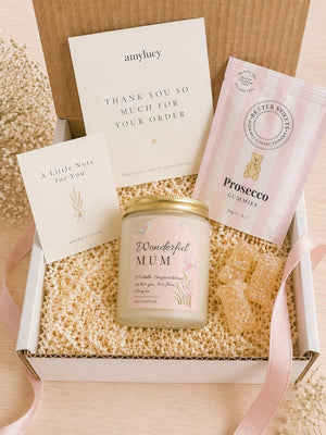 Lit personalised New Baby Candle Gift in a styled setting