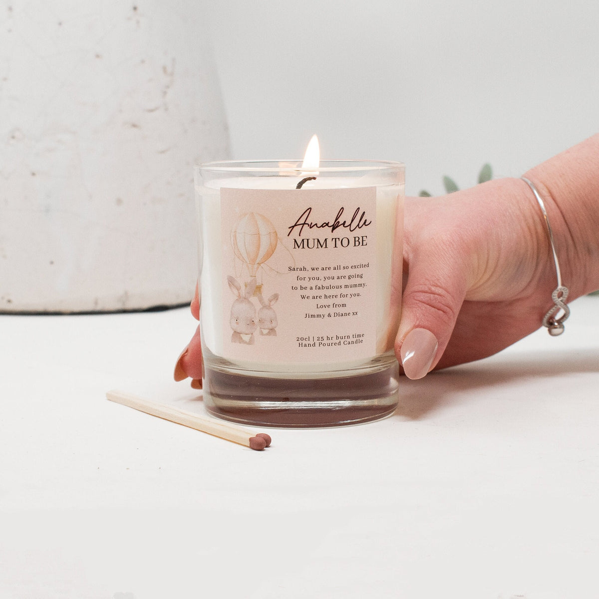 Close-up of the personalised label on the personalised Rainbow New Baby Candle Gift