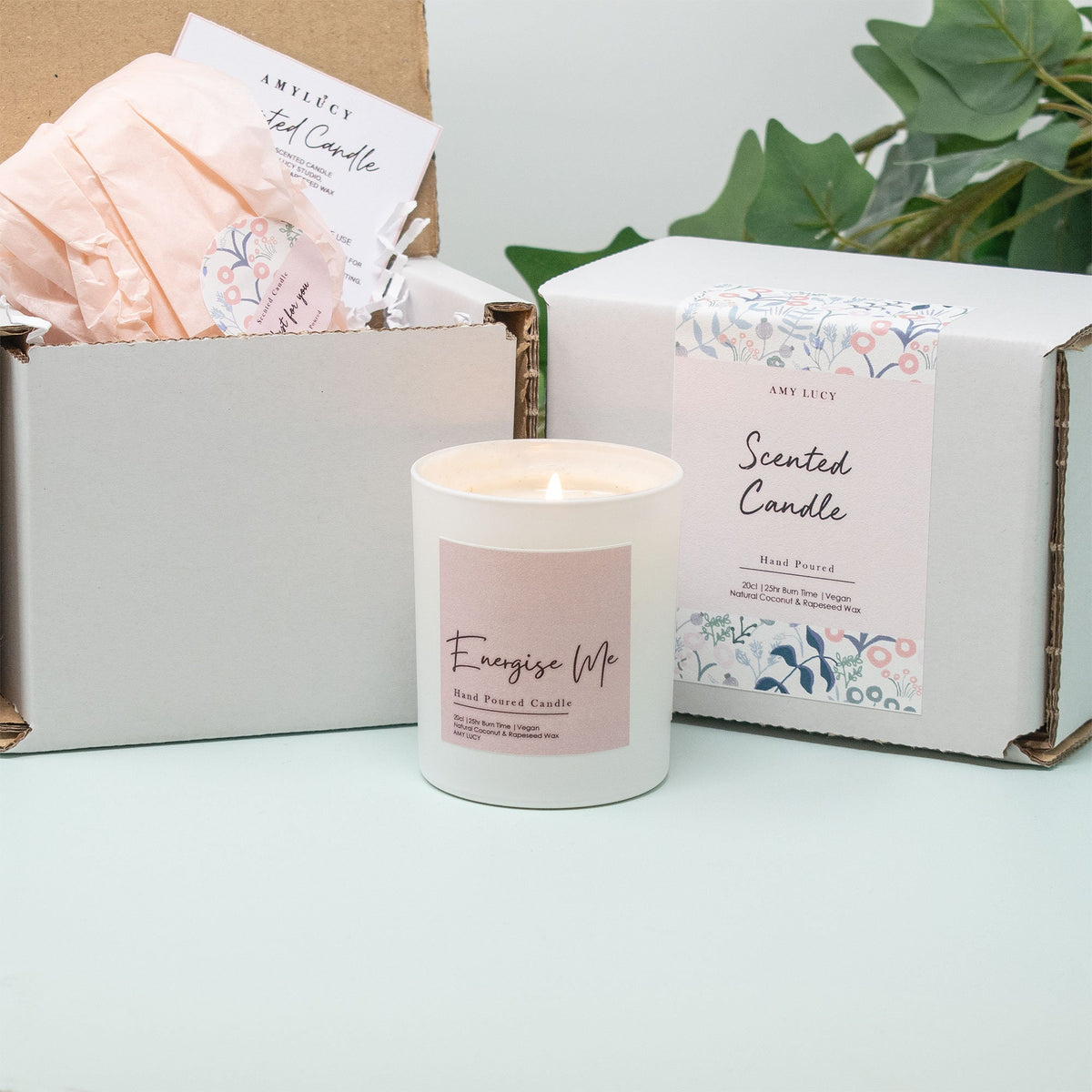 Lit personalised Rainbow New Baby Candle Gift in a styled setting