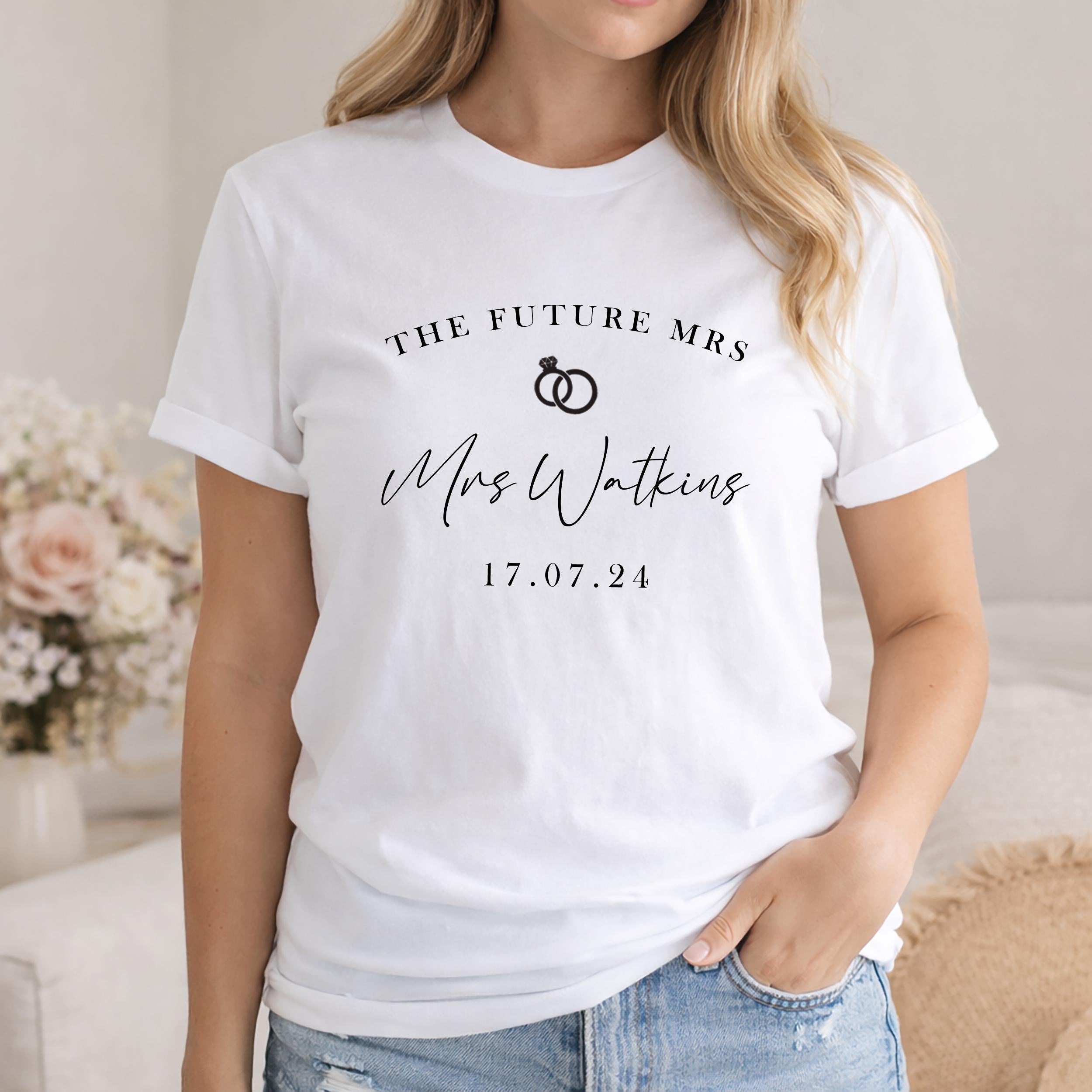 White t-shirt with 'The Future Mrs' text and personalized name and date on a blurred background